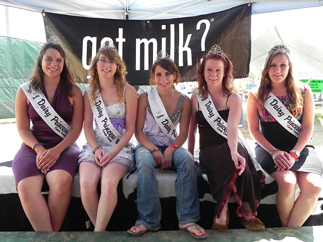 Dairy Princesses post in front of a 'got milk?' banner