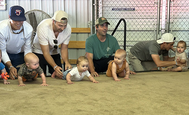 dads prepare their babies for the Carver County Fair diaper derby