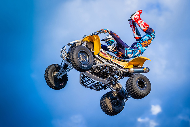 a rider does a trick in middair at the ATV Big Air Tour
