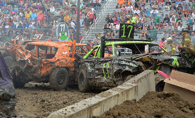 two brightly painted cars crash during the Carver County Fair Demolition Derby