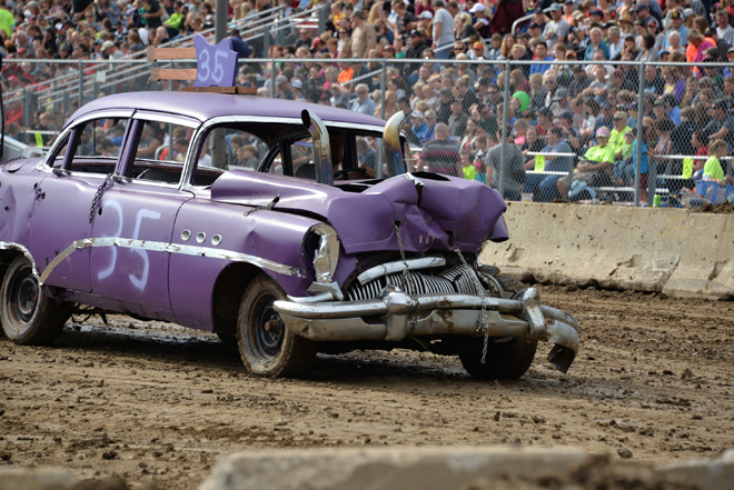 a smashed up antique purple car at the Carver County Fair Demolition Derby