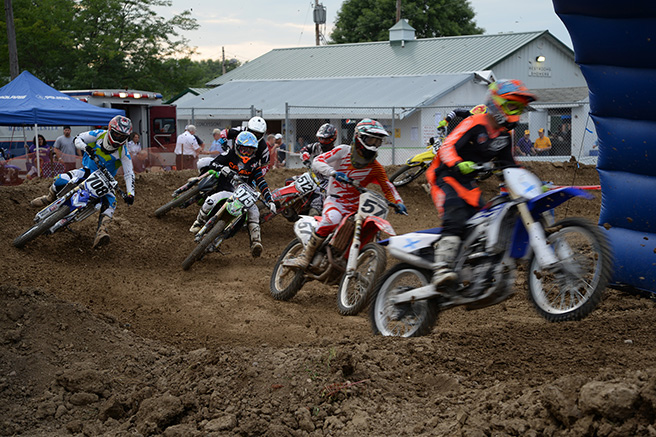 Motokazie racers go around a corner in the Carver County Fair Grandstand