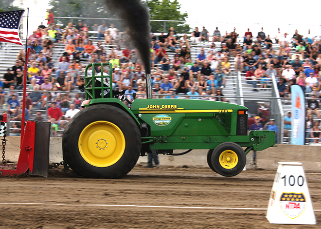 John Deere tractor pulling in the NTPA Tractor Pull at the Carver County Fair