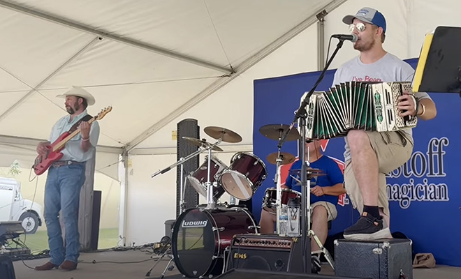 Colton Tupy plays accordion with his band
