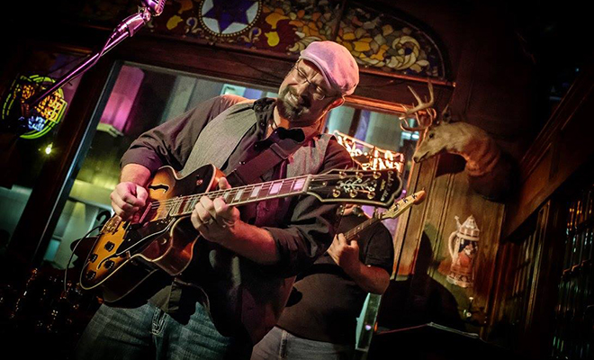 Jason Paulson performing on guitar