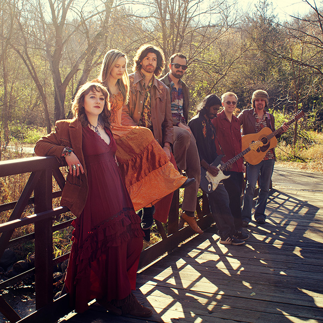 members of the band Sawyers Dream pose on a bridge